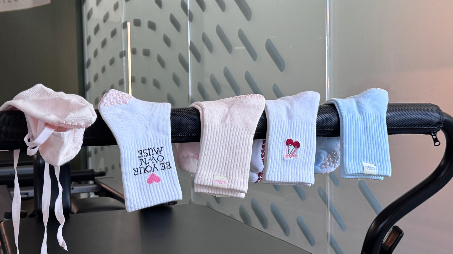 Five pairs of Air\e Crew  pilates grips socks in soft pastel colors.