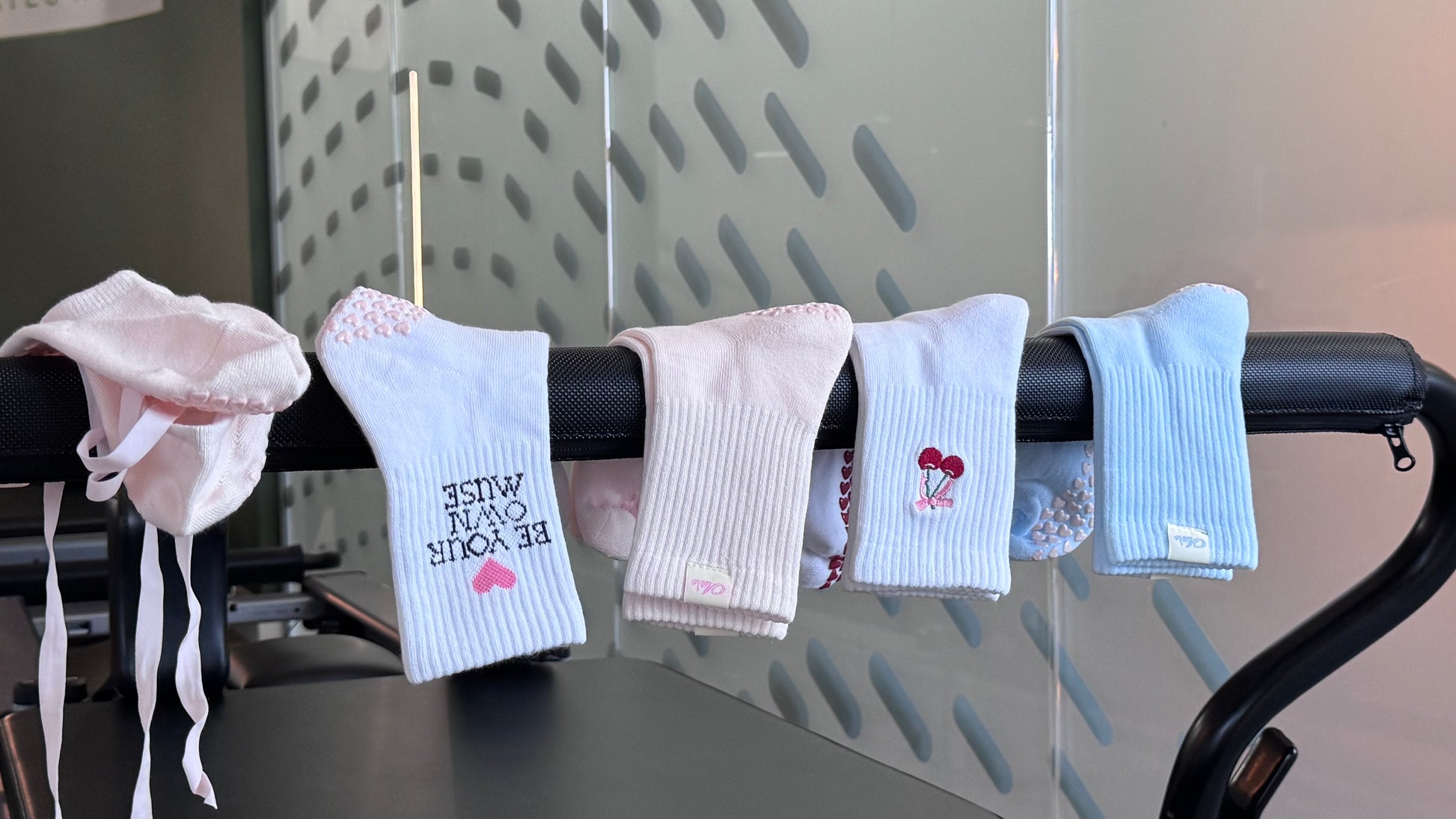 Five pairs of Air\e Crew  pilates grips socks in soft pastel colors.